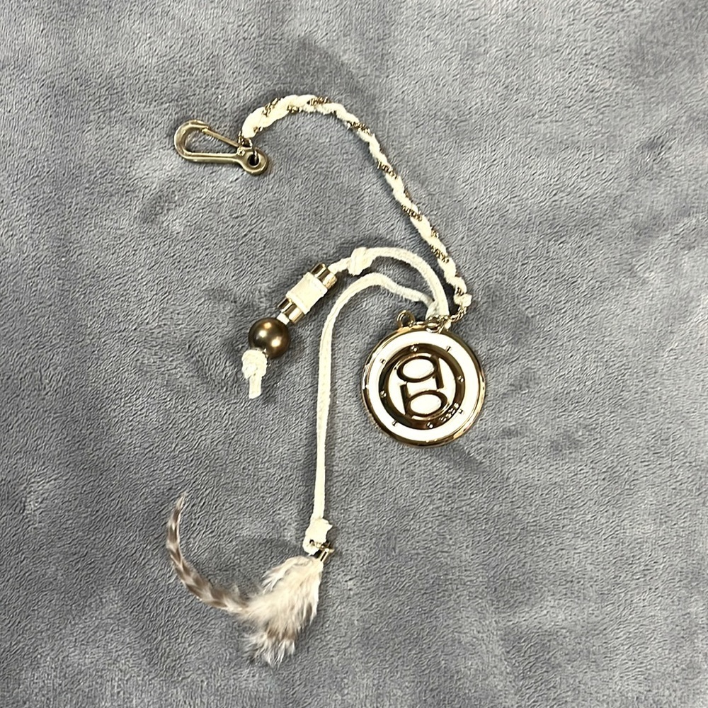 Bebe White and Gold Key Chain
